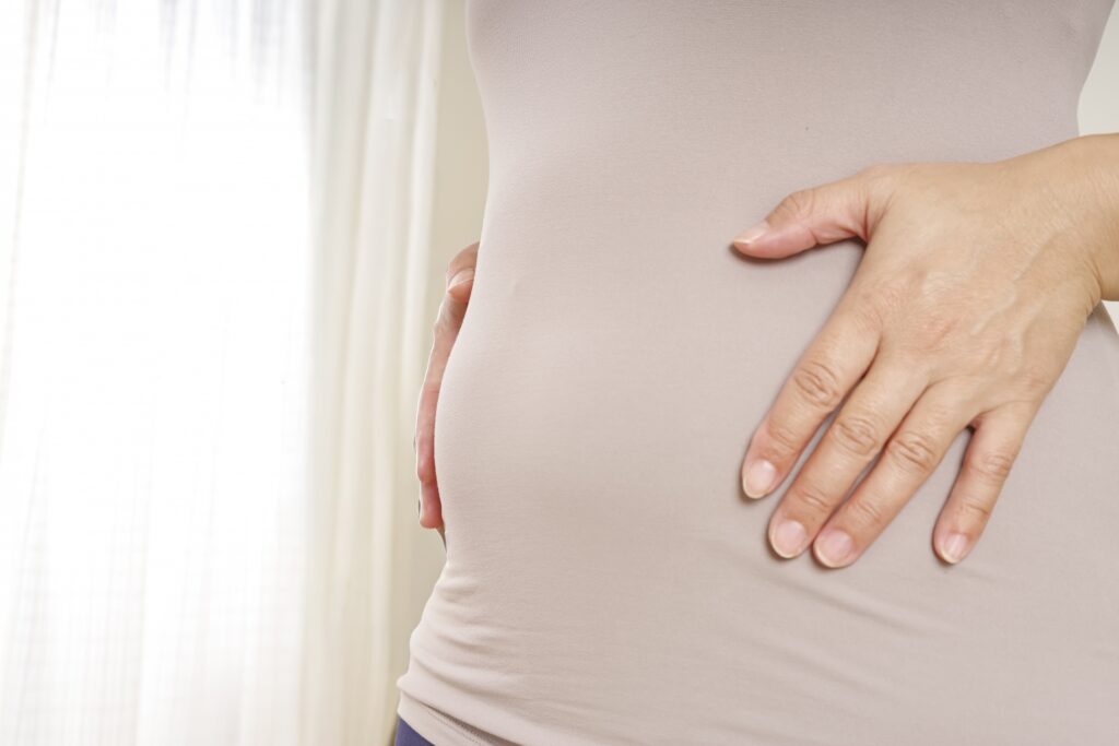 お腹周りの皮下脂肪を気にする中年女性